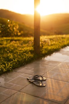 Serene sunset in Minas Gerais with flip flops, capturing warmth and tranquility of the evening sun.