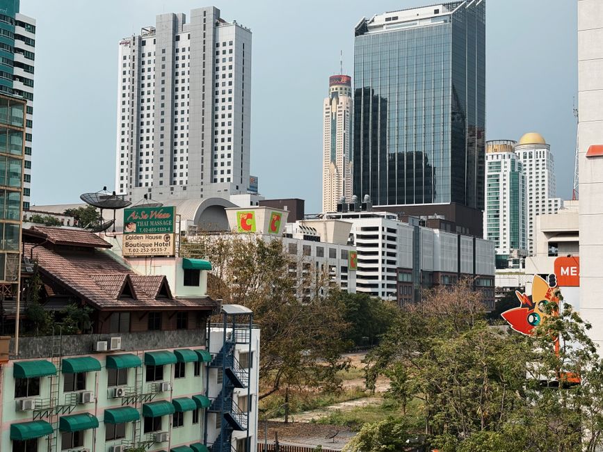 A cityscape of Bangkok with modern skyscrapers and traditional architecture, capturing the urban essence.