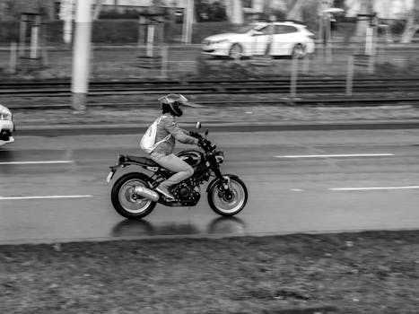 Motorcyclist commuting on an urban street in motion blur effect