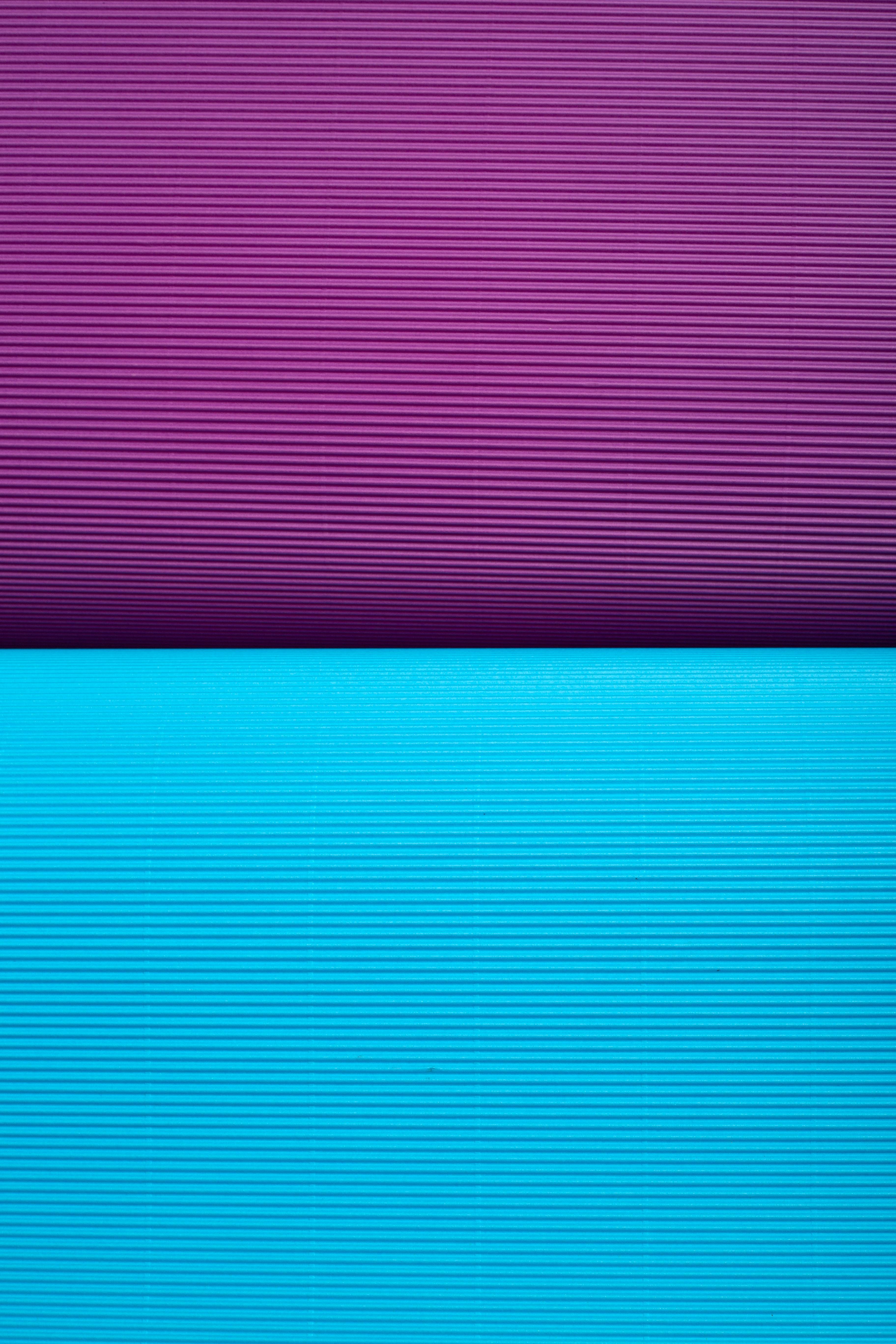 Free Close-up of two colorful yoga mats, emphasizing texture and color contrast. Stock Photo