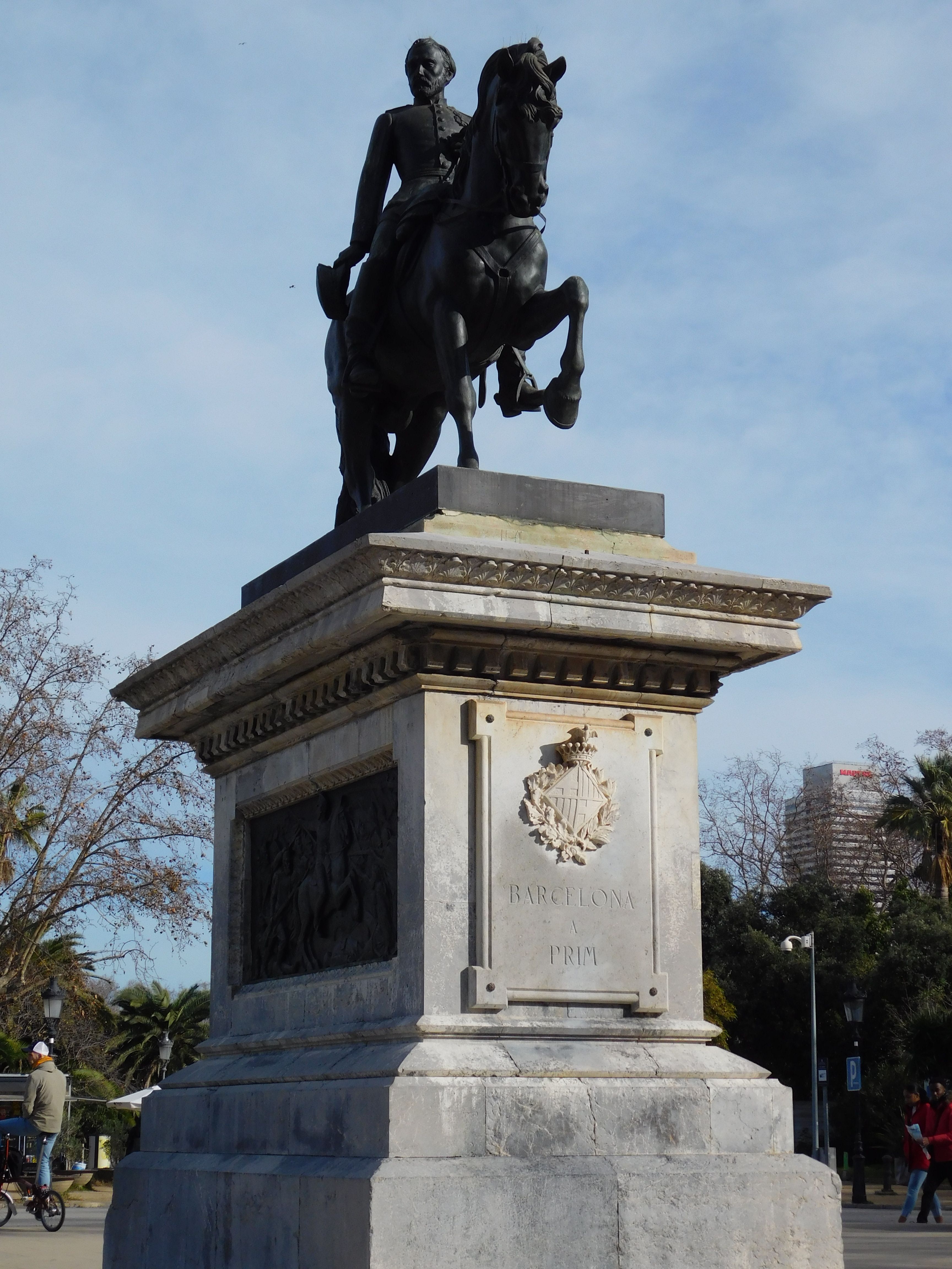 An equestrian statue in a park in Barcelona with a clear sky backdrop.