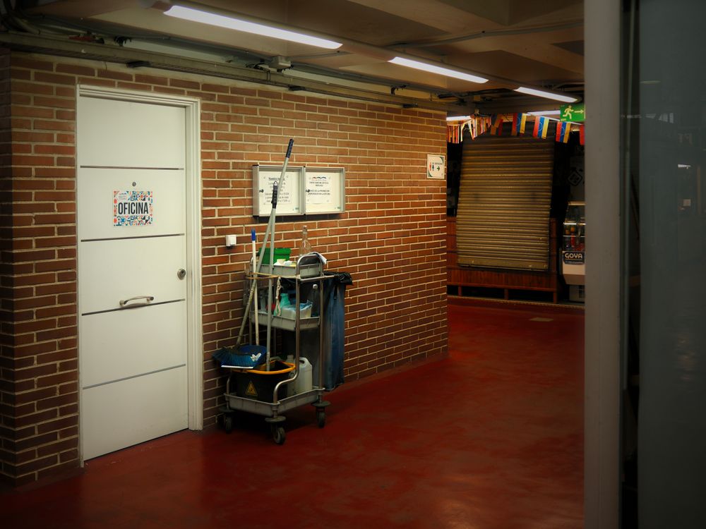 Cleaning cart in a bright office hallway