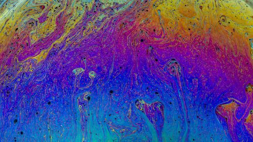 Free Explore a vibrant abstract art piece featuring swirling multicolored patterns resembling liquid textures. Stock Photo