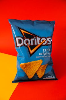 A vibrant image of a Doritos Cool Original bag against a red and yellow backdrop.