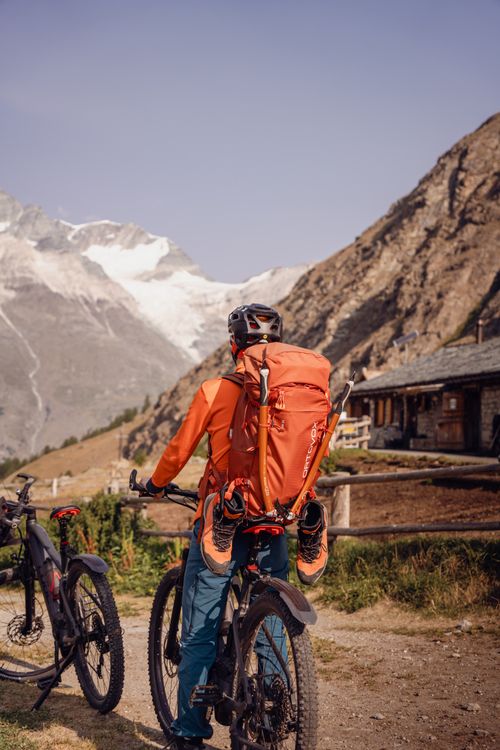 Free Mountain biker enjoying the scenic views in Randa, Wallis, Switzerland with majestic peaks in the background. Stock Photo