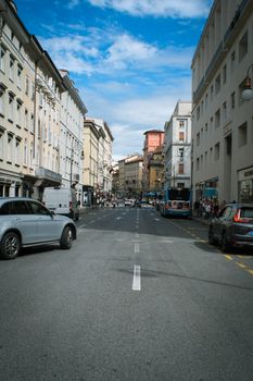 A bustling street scene in an urban area with classic architecture and lively activity.