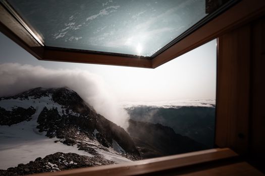 Breathtaking view of Italian Alps from a cozy cabin window in Trentino-Südtirol.