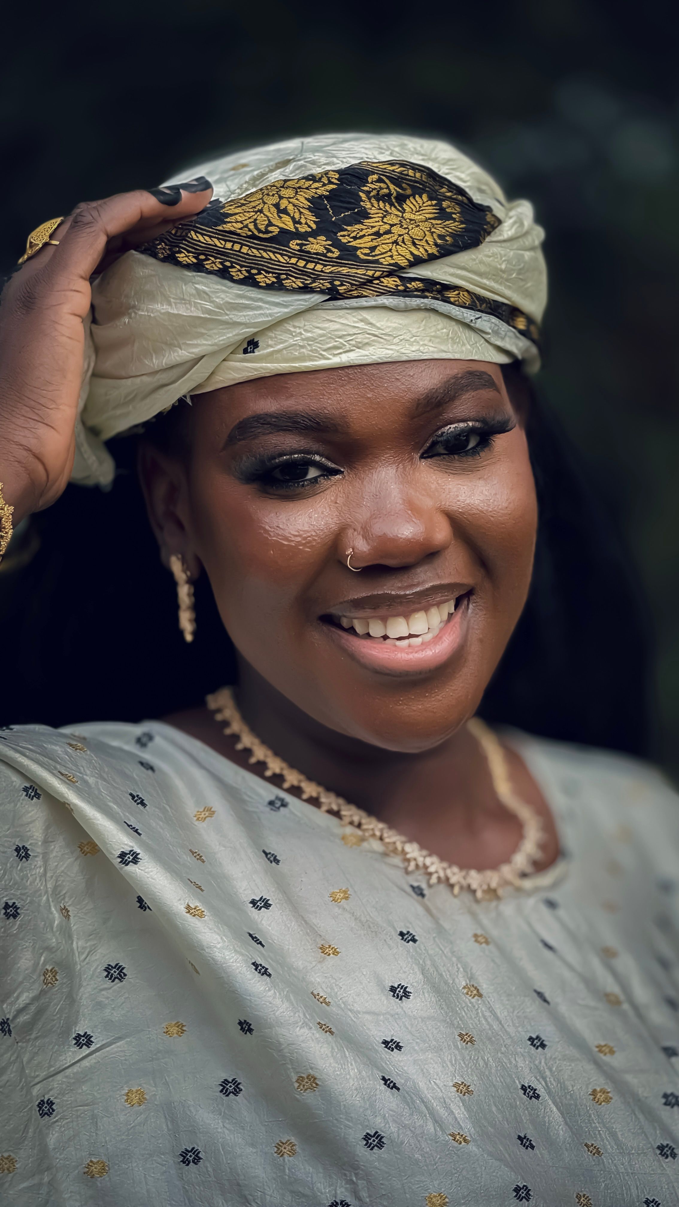 Smiling Woman in Traditional Attire Relaxing Outdoors · Free Stock Photo