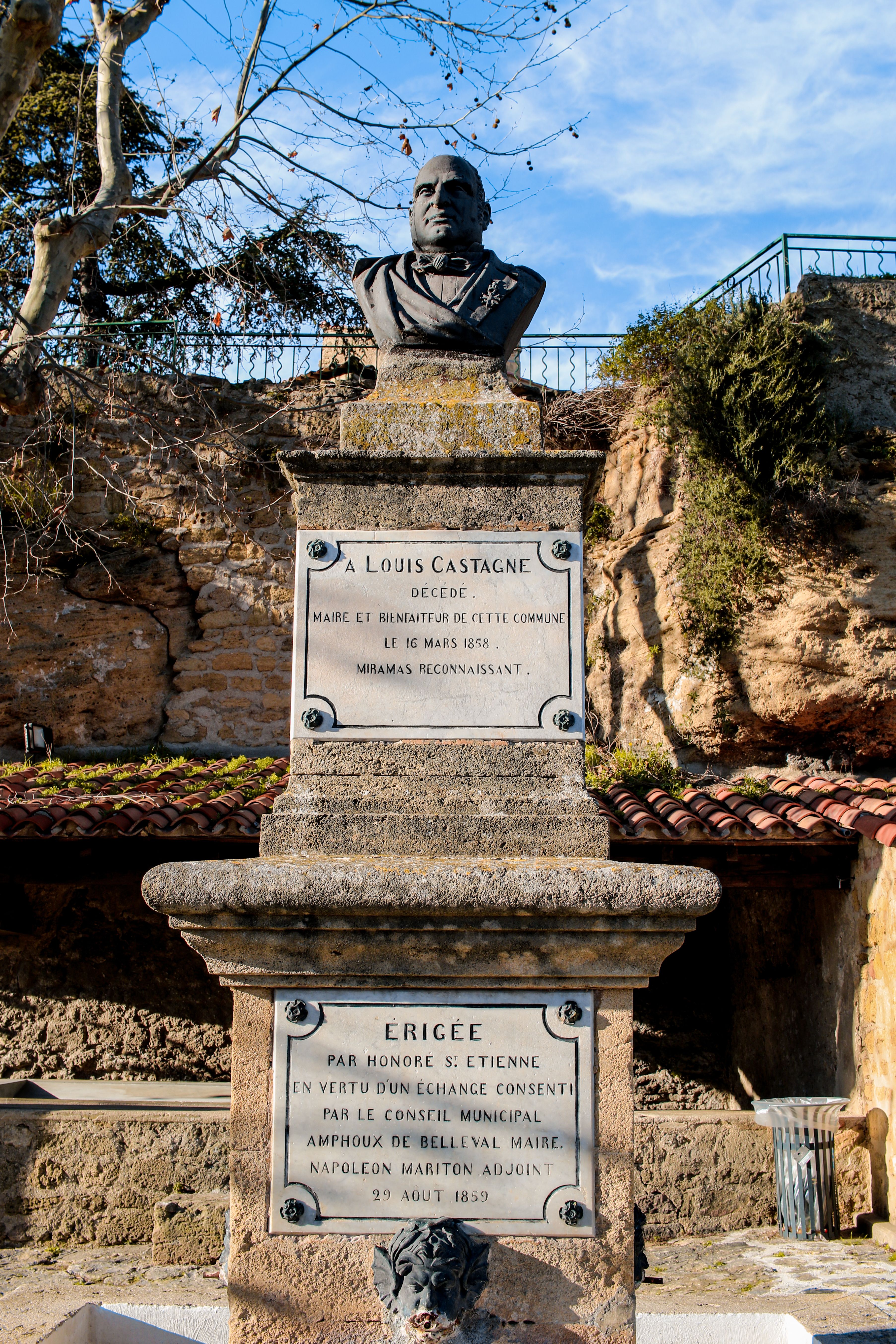 Bust of Louis Castagne on a stone pedestal in Miramas, France, with engraved inscriptions.