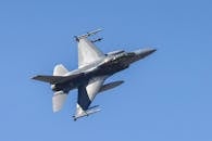 F-16 Fighter Jet in Flight Against Clear Blue Sky