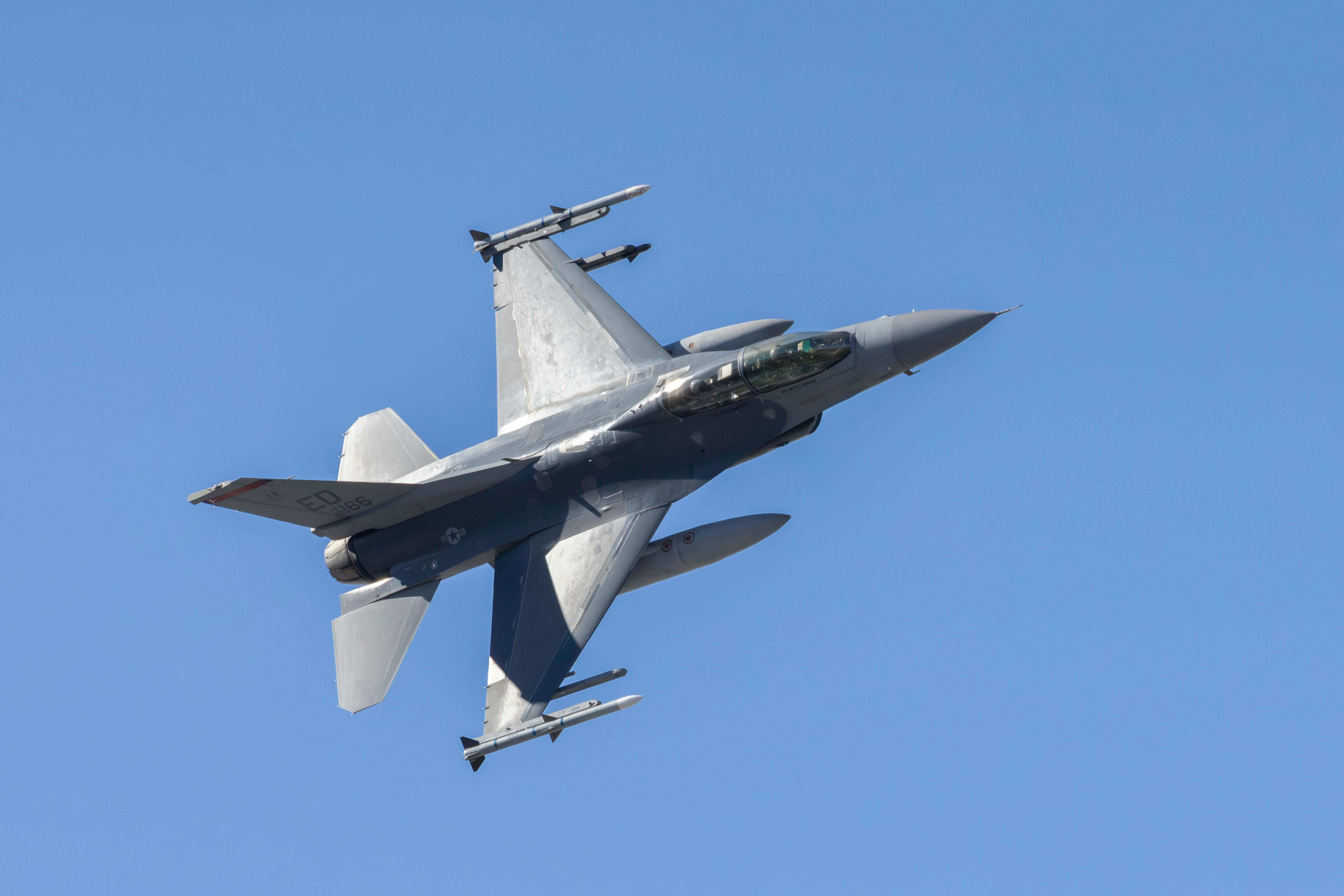 F-16 Fighter Jet in Flight Against Clear Blue Sky