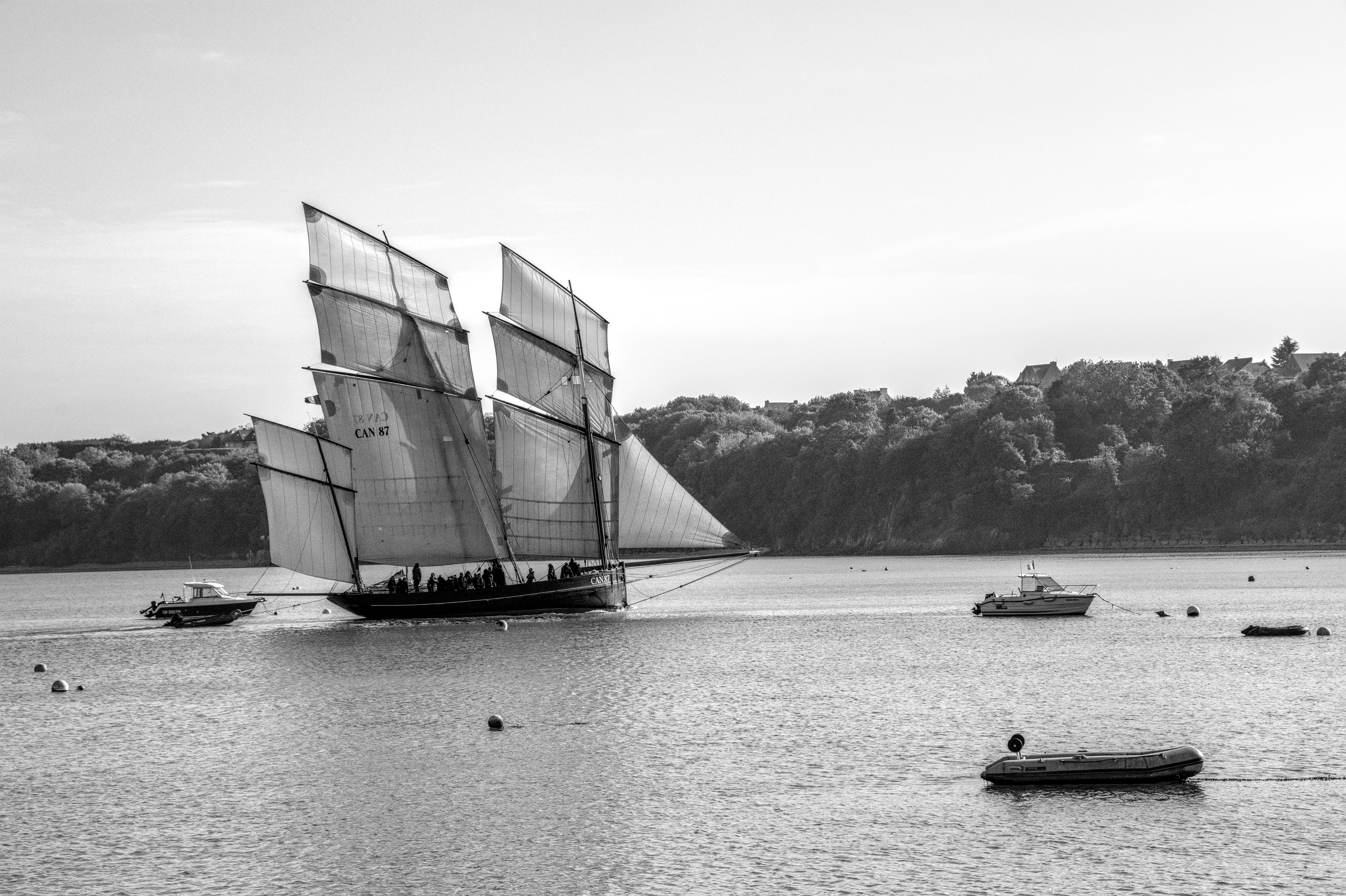 Black and white photo of a vintage sailing ship on calm waters in Brittany, France.