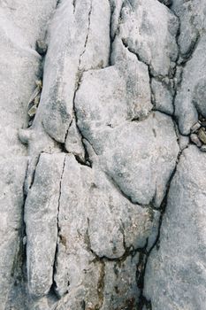 Close-up of cracked limestone rock texture in Konaev, Kazakhstan.