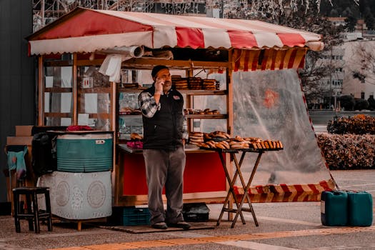 A street vendor stands by his pastry stall in Izmir's vibrant outdoor market.
