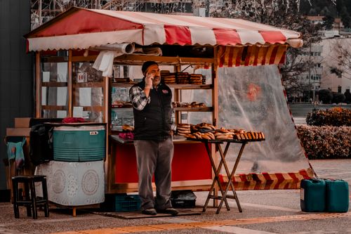 Free A street vendor stands by his pastry stall in Izmir's vibrant outdoor market. Stock Photo
