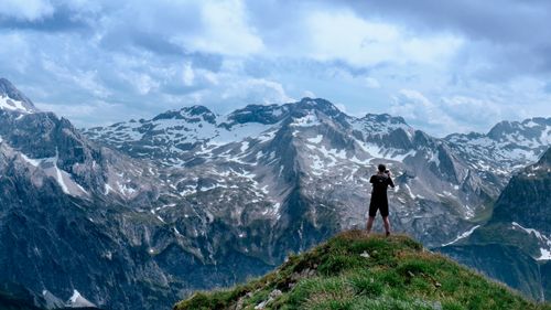 Free A lone hiker photographs the breathtaking snowy mountains in Vorarlberg, Austria. Stock Photo