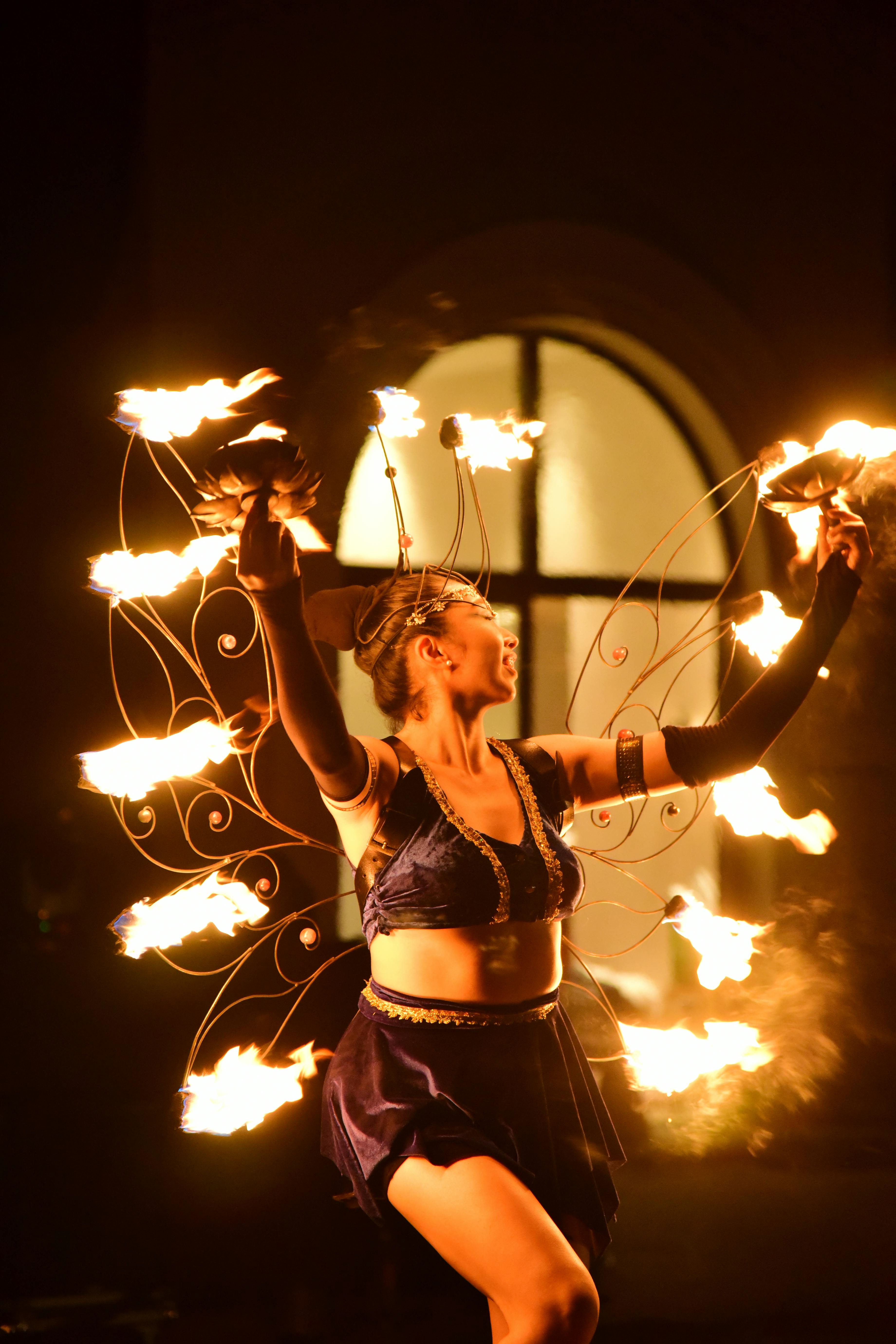 Gratis Seorang penari api yang memukau menampilkan atraksi dengan lingkaran api di tengah suasana gelap. Foto Stok