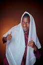 Young Man in Traditional Attire with Thumbs Up