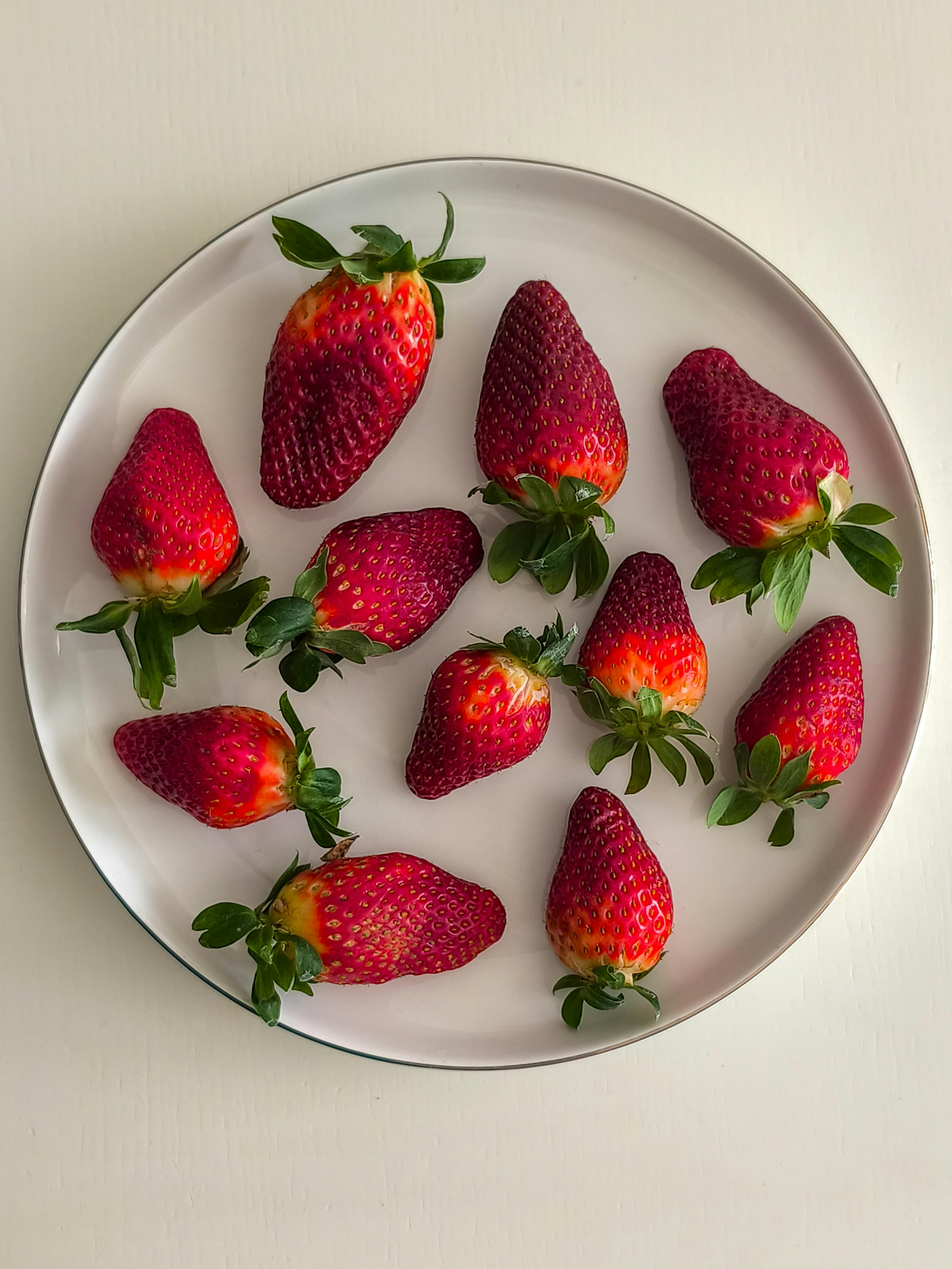 Gratis Tampilan atas buah stroberi merah segar di atas piring putih, sempurna untuk resep musim panas. Foto Stok