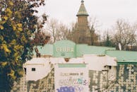 Old Building with Flora Sign and Church Tower