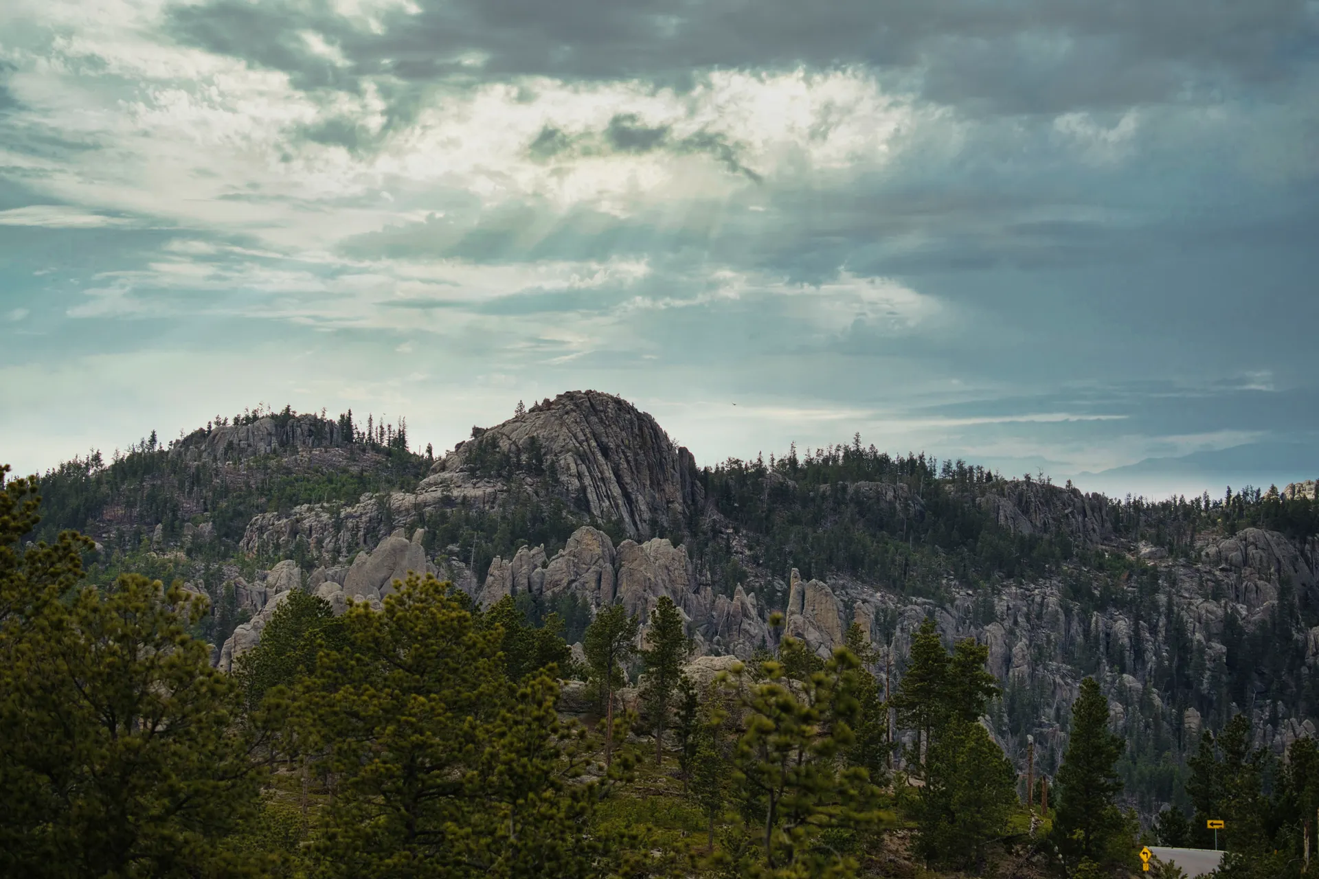 Landscape of the Black Hills with rocky mountains and lush forests under cloudy skies. Landscape of the Black Hills with rocky mountains and lush forests under cloudy skies.