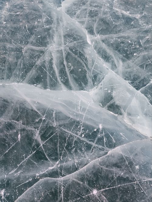 Free Captivating image of natural ice cracks on a frozen surface, showcasing winter beauty. Stock Photo
