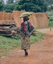 African Woman Walking in Traditional Attire, Tanzania