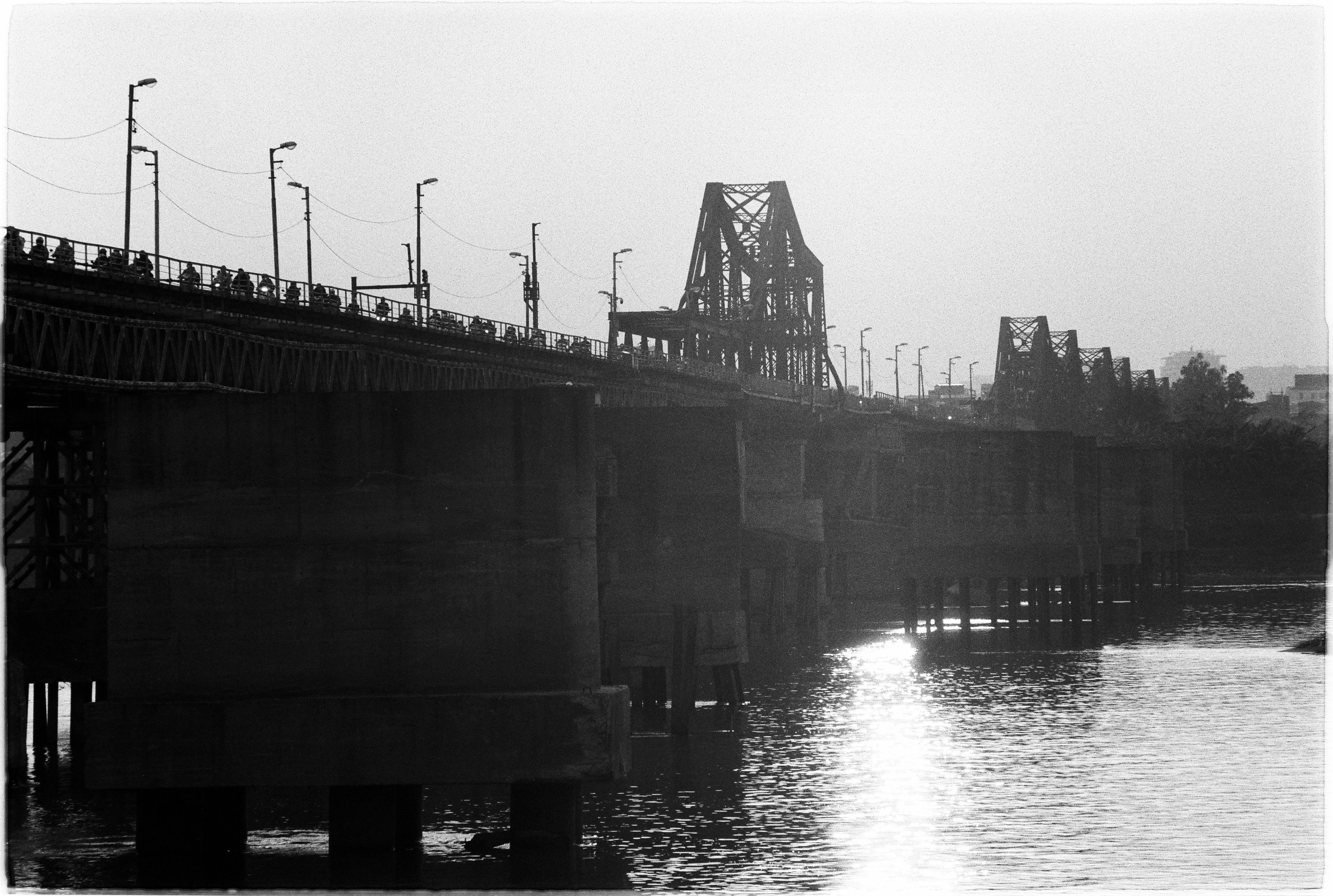 Black and White Bridge Over River at Dusk · Free Stock Photo