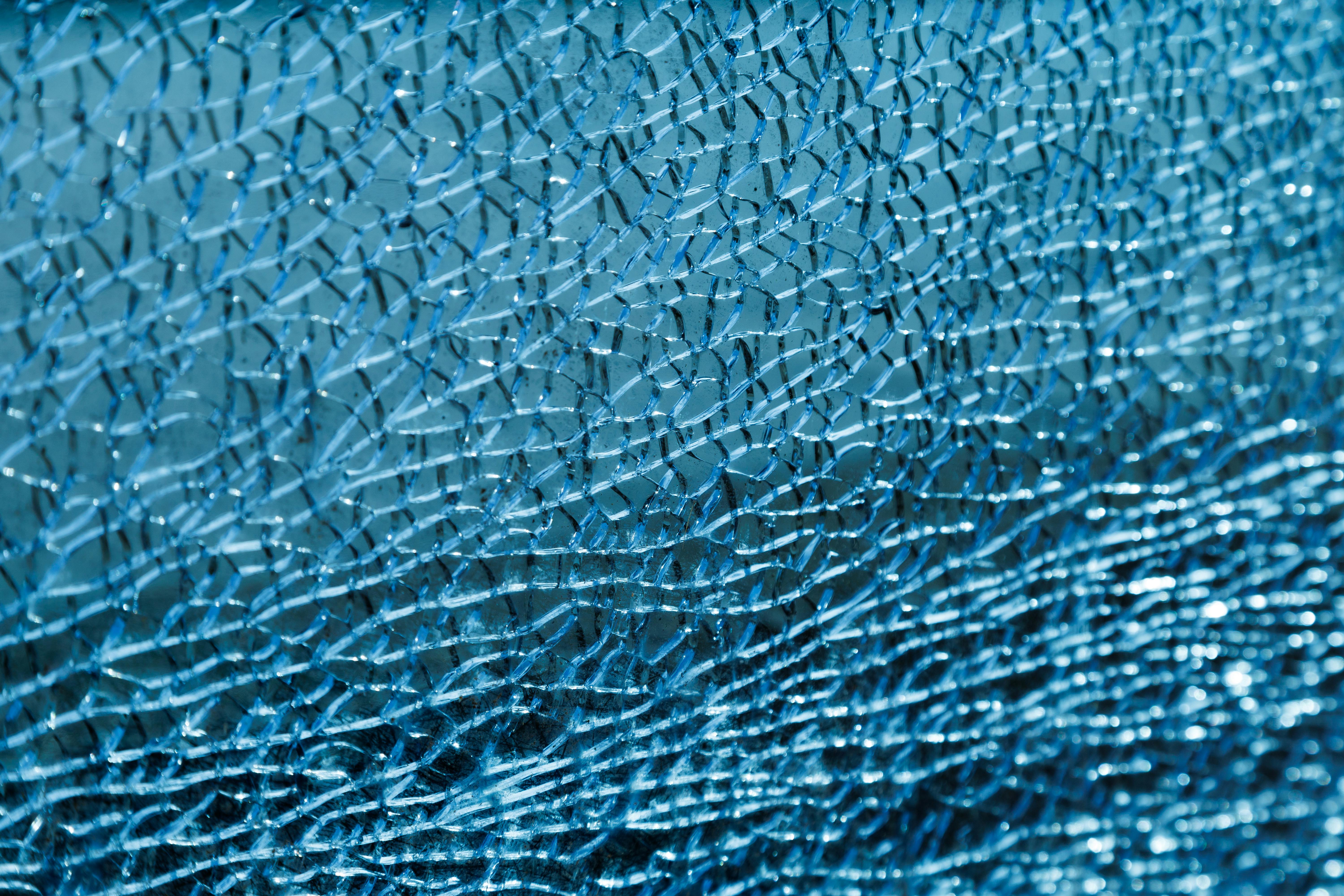 Free Detailed view of cracked blue glass texture with intricate patterns. Stock Photo