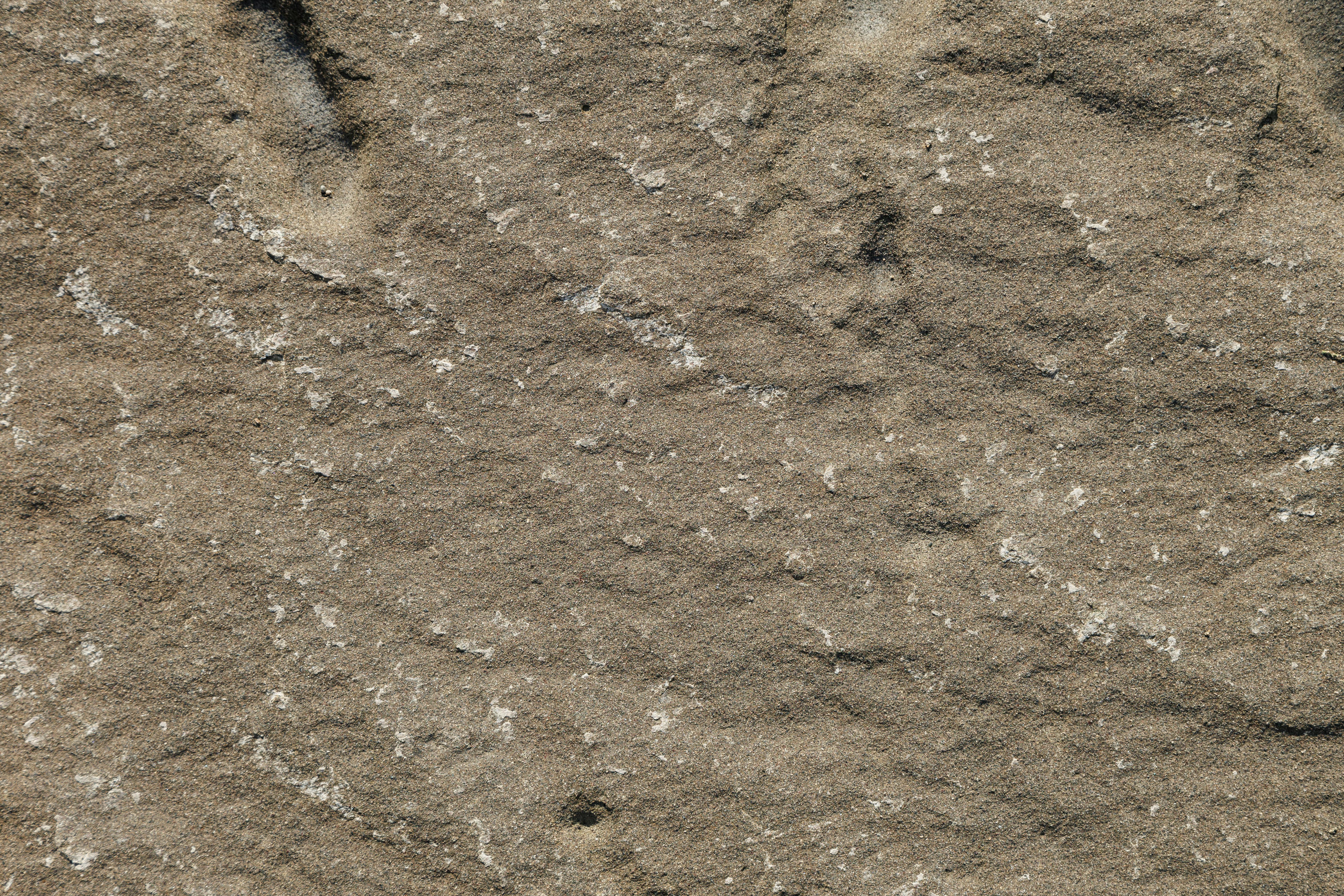 Gratuit Texture détaillée d'une surface rocheuse en grès érodée, idéale pour les arrière-plans. Photos