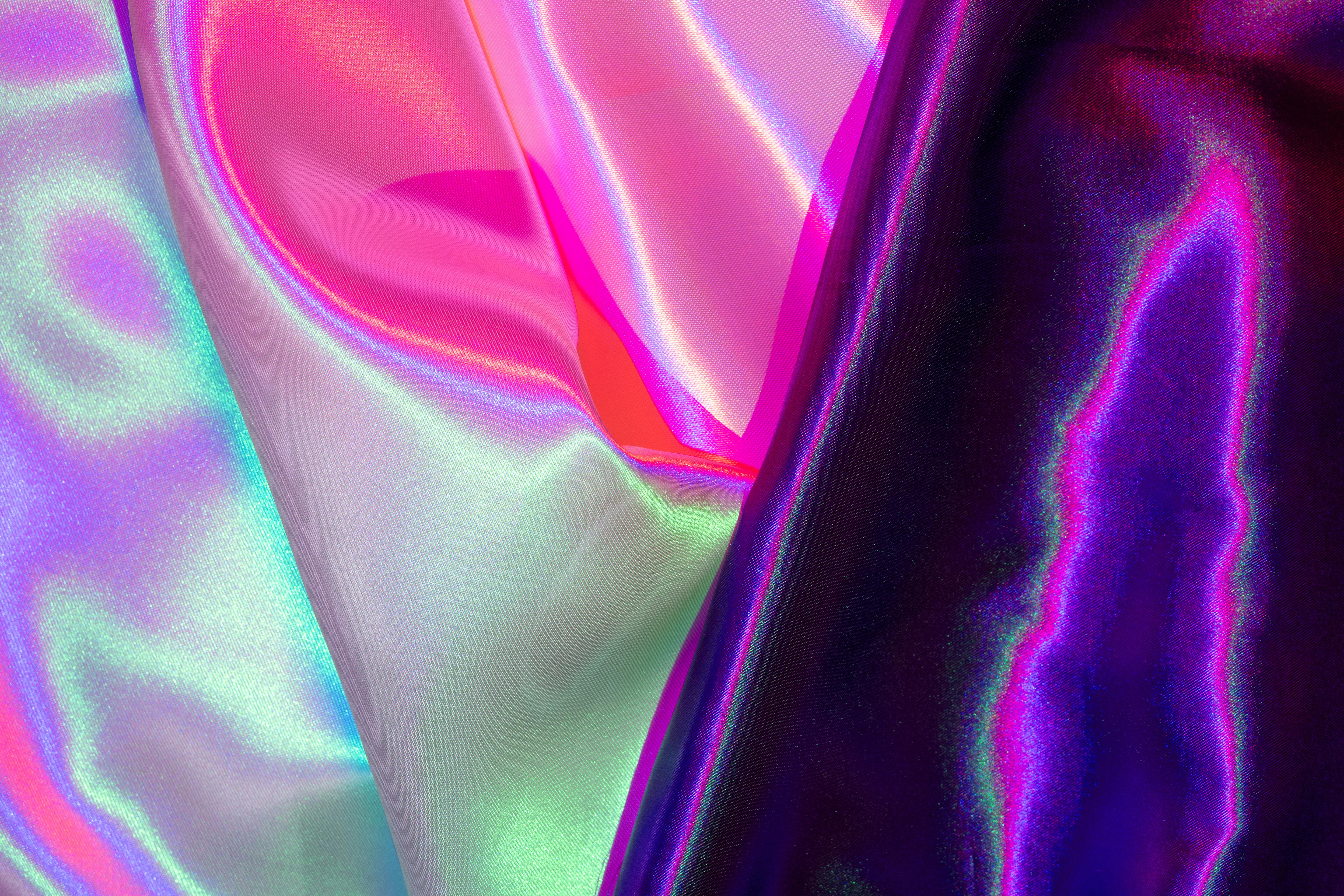Free Colorful iridescent fabric with vibrant pink, purple, and blue hues creates a mesmerizing abstract texture. Stock Photo