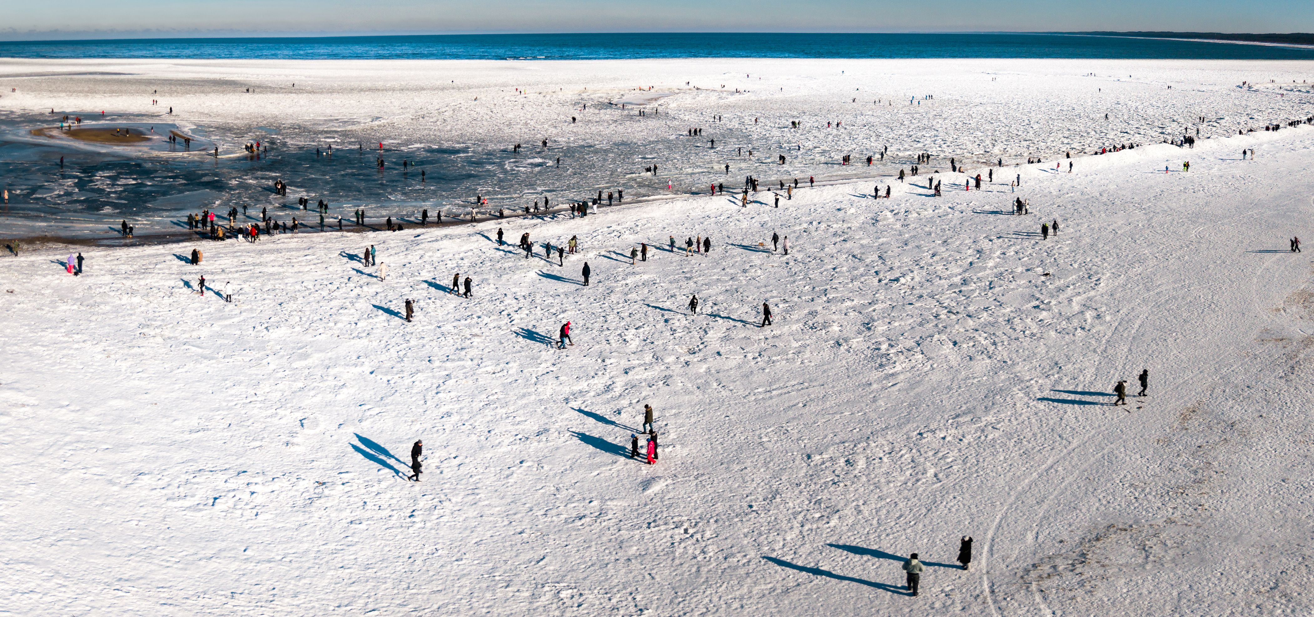 Aerial View of People Enjoying Snowy Beach Landscape · Free Stock Photo