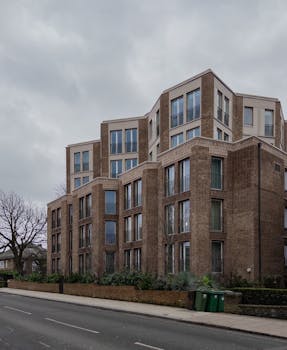 Stylish brick apartment building in Hampstead, London, showcasing contemporary architecture under a cloudy sky.