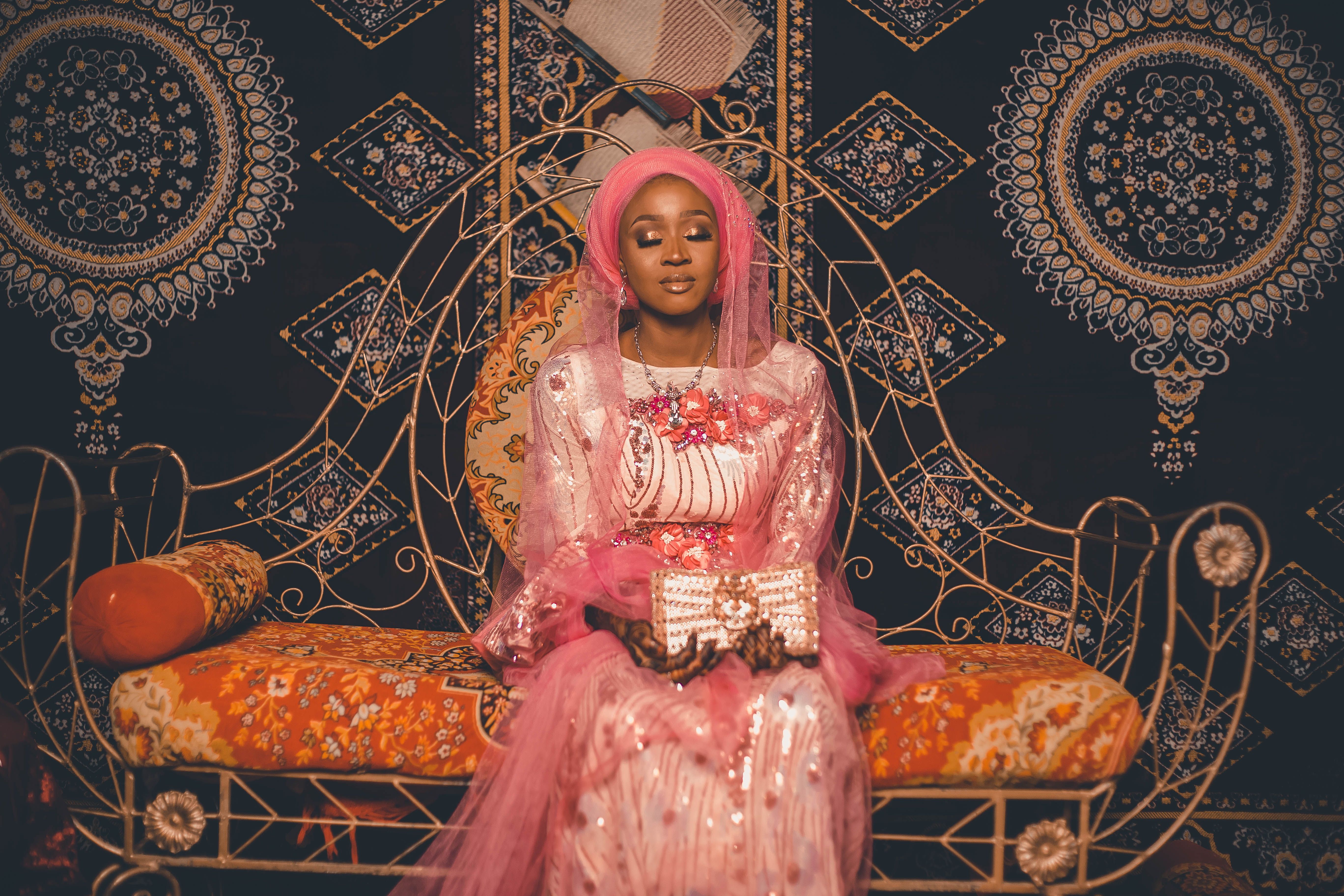 Elegant Woman in Traditional Pink Attire Indoors · Free Stock Photo
