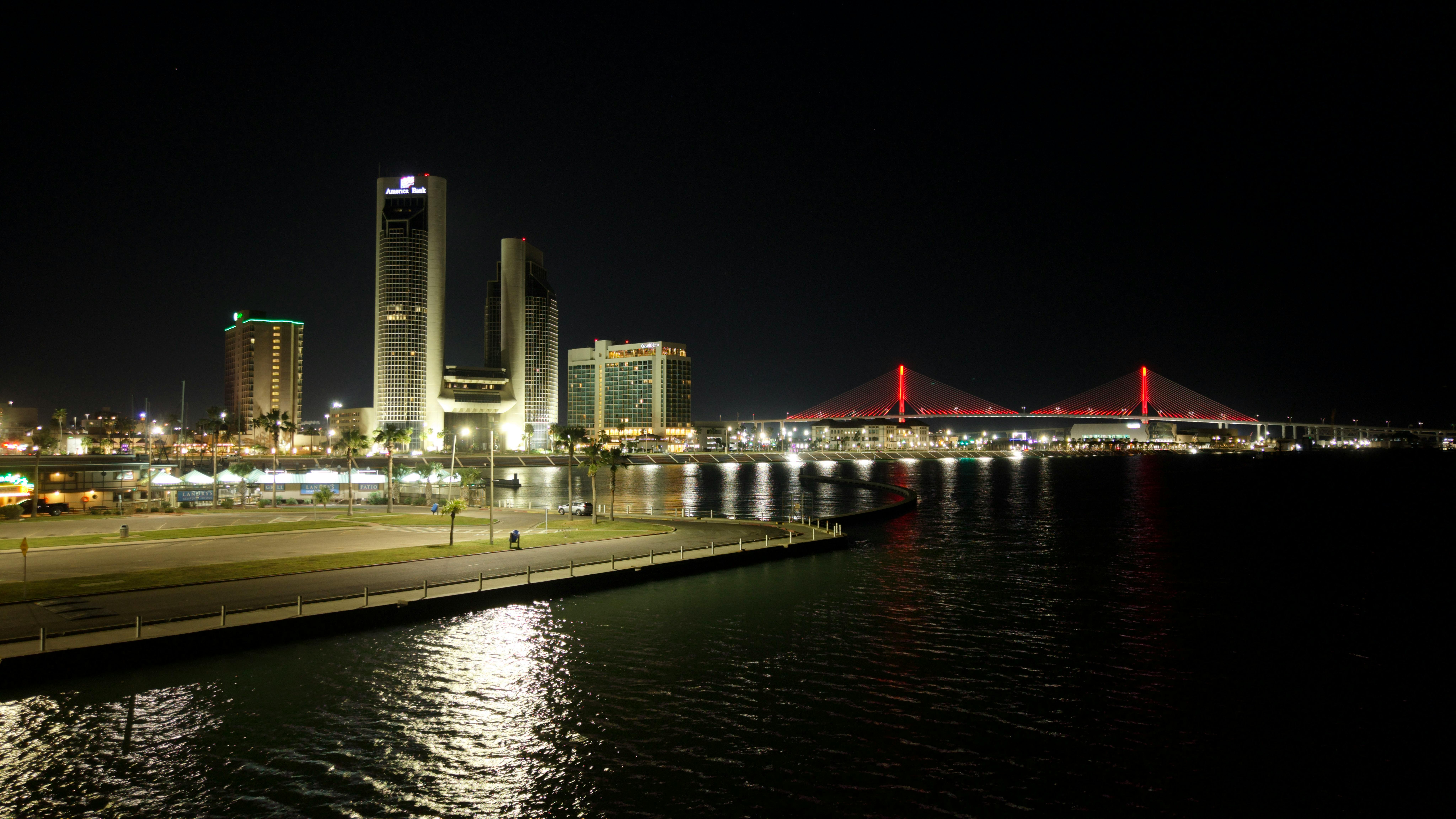 Stunning night view of Corpus Christi skyline and illuminated Harbor Bridge.