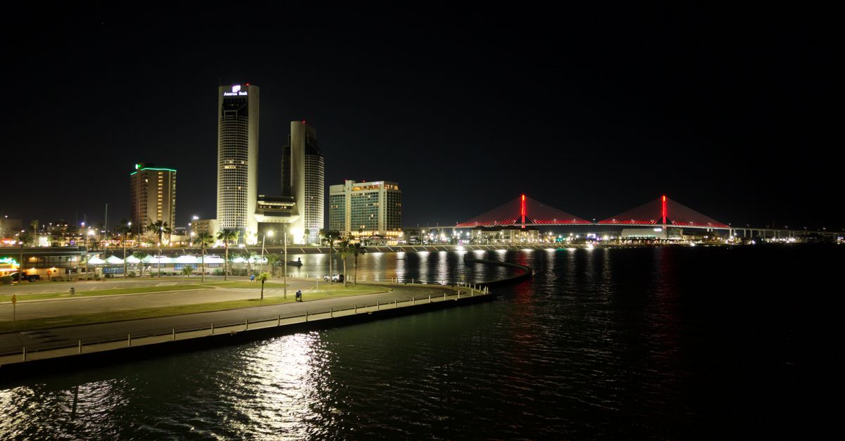 Stunning night view of Corpus Christi skyline and illuminated Harbor Bridge.