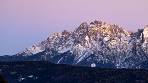 Free Beautiful sunset view of the snow-capped Dolomites, highlighting the mountain's rugged peaks and serene atmosphere. Stock Photo