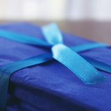 Small gift box tied with a satin ribbon, photo by Suzy Hazelwood on Pexels