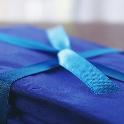 Blue wrapped gift box with a satin ribbon, photo by Suzy Hazelwood on Pexels