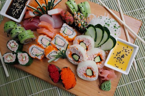 Free Colorful sushi platter with assorted rolls and dipping sauces, perfect for a gourmet meal. Stock Photo