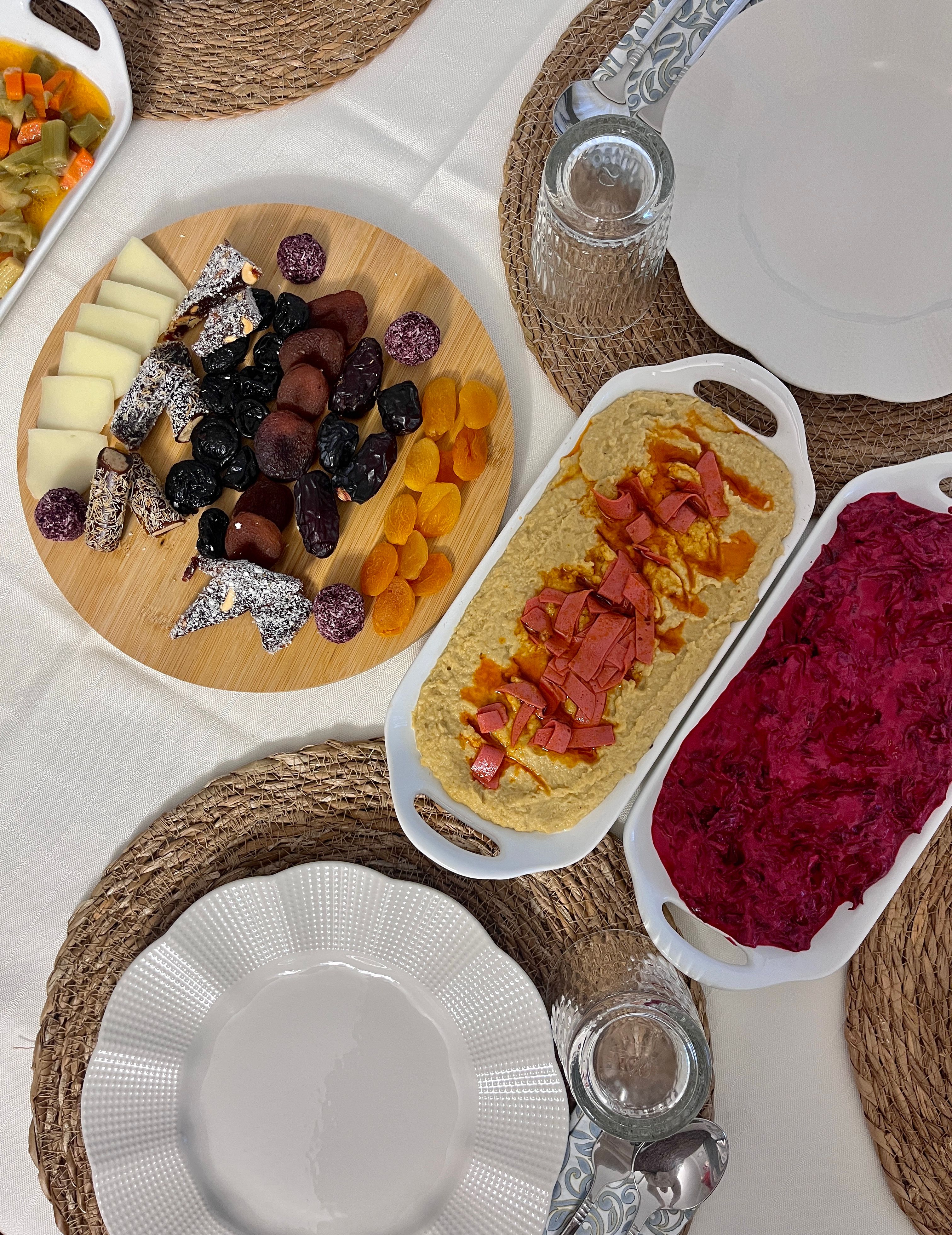 Aesthetic table setting featuring an assortment of appetizers with a warm, inviting atmosphere.