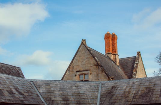 Classic British architecture with a brick chimney against a blue sky in Shrewsbury, England.