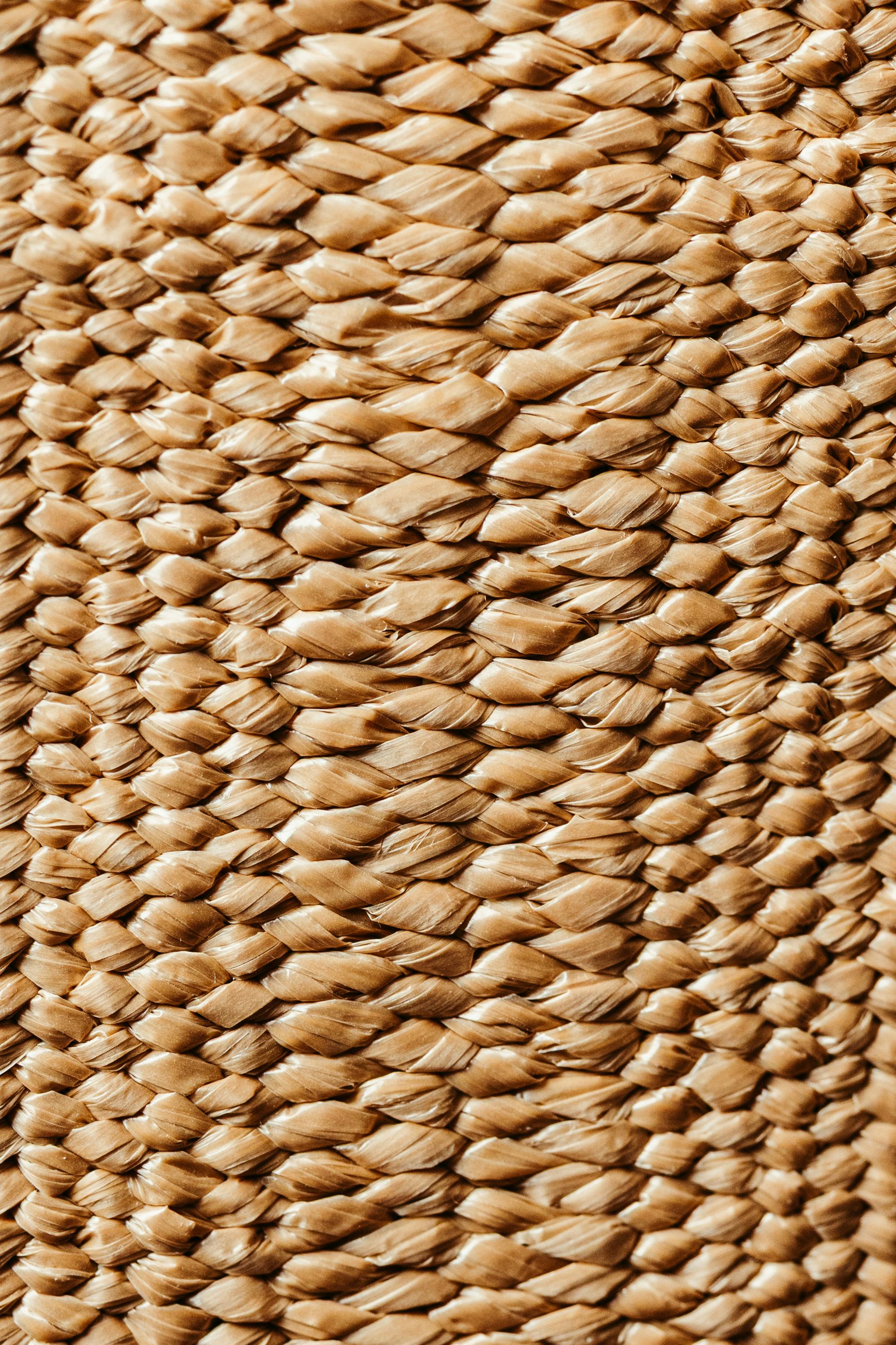 Free Detailed close-up of a woven natural material showcasing its textured pattern and earthy tones. Stock Photo
