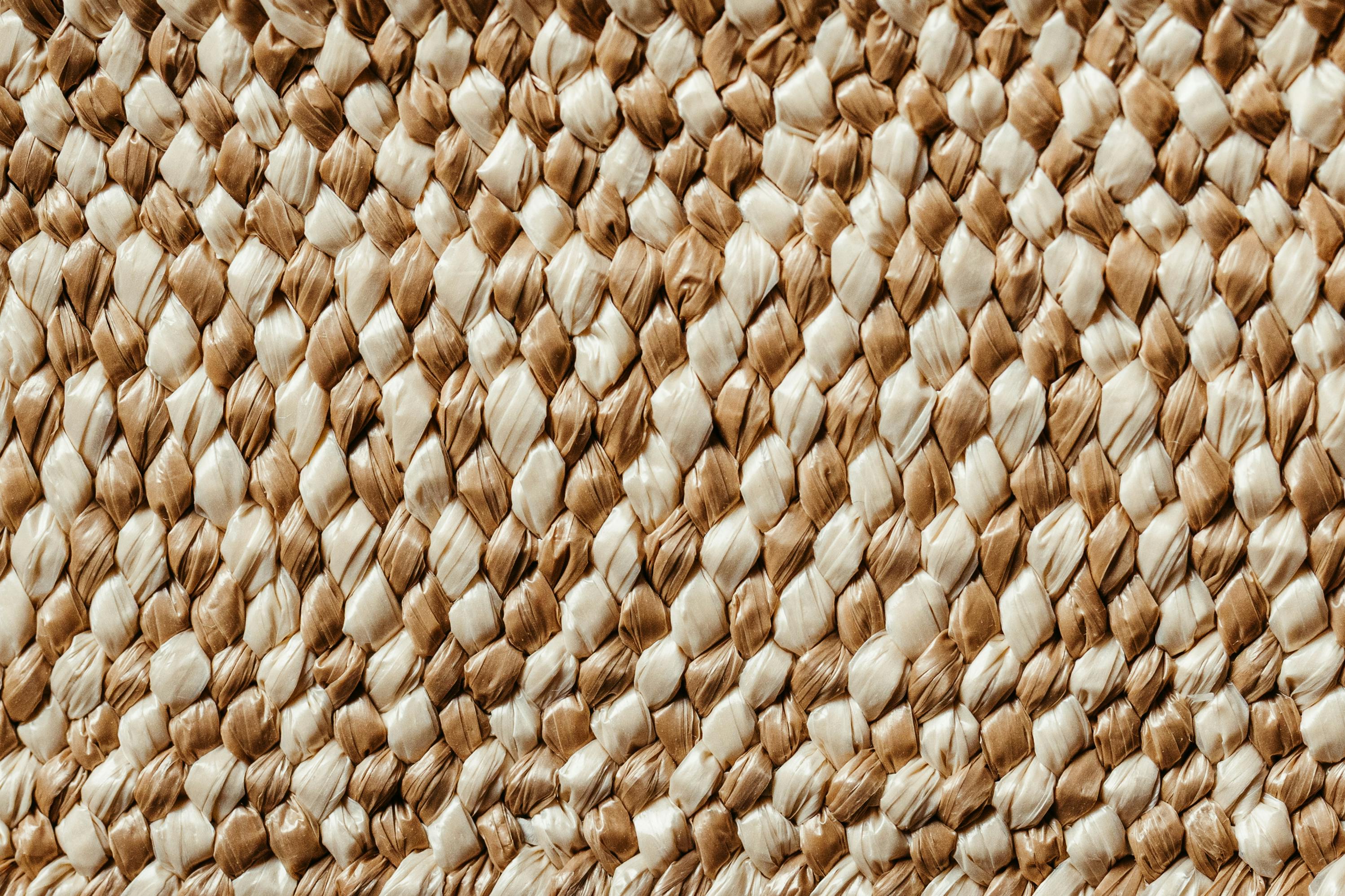 Free Detailed close-up of a woven natural fiber texture, showcasing intricate patterns and warm earthy tones. Stock Photo