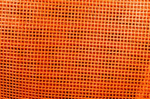 Free Close-up of an orange plastic mesh texture suitable for backgrounds and design. Stock Photo