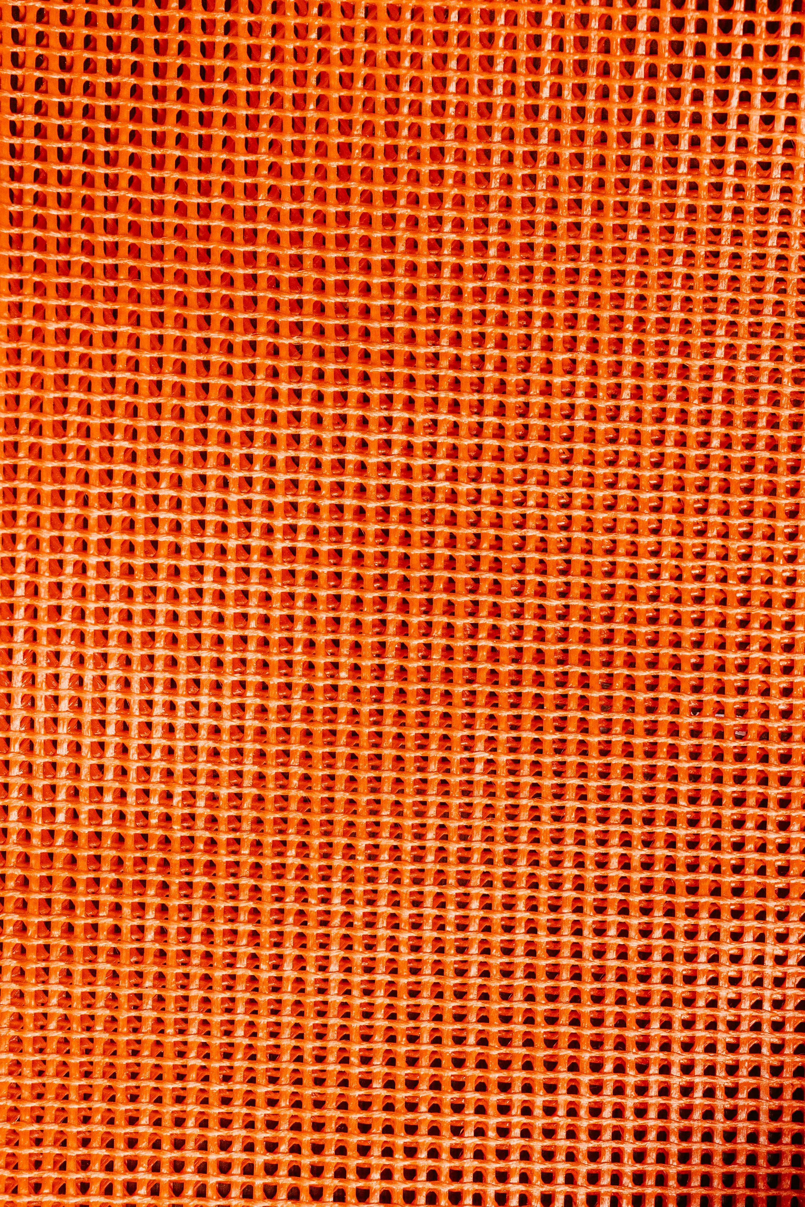 Bezpłatne Soczysta pomarańczowa siateczkowa tekstura tworząca abstrakcyjne tło z żywym wzorem siatki. Zdjęcie z galerii