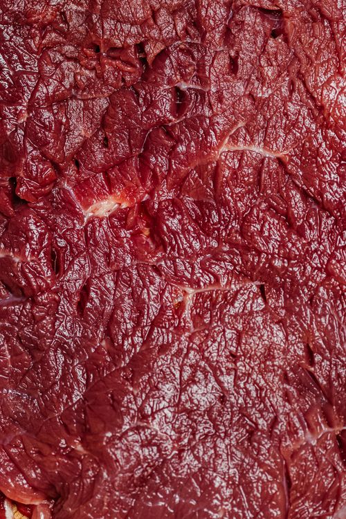 Free Macro shot showcasing the intricate texture of raw beef, highlighting its fibrous and marbled surface. Stock Photo