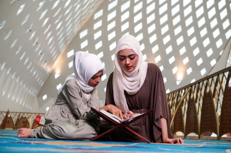 Mother and daughter studying the Quran together