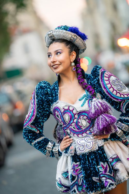 Free Colorful street portrait of a woman in a vibrant traditional costume with sequins and embroidery. Stock Photo
