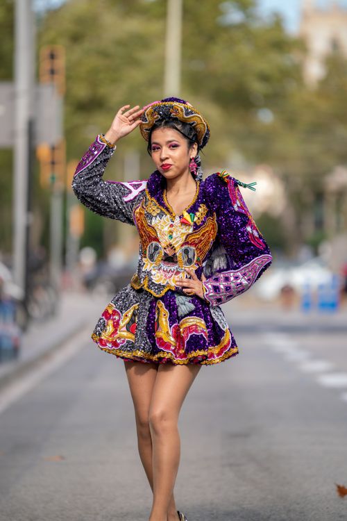 Free Portrait of a woman in vibrant traditional dance costume during street parade. Stock Photo